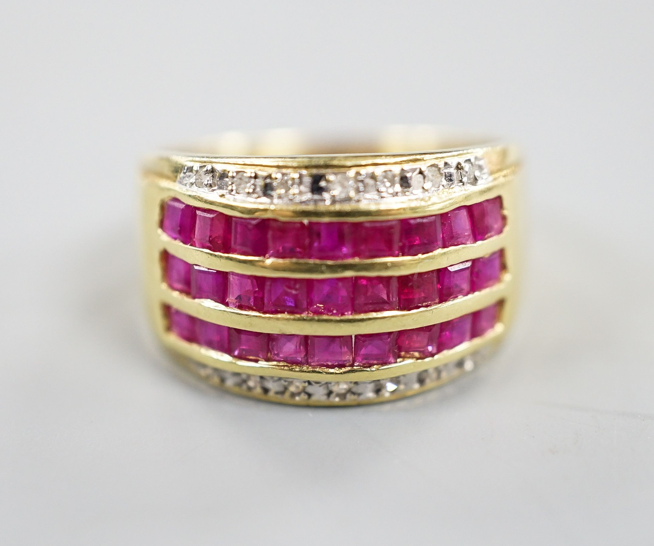 A modern 14k yellow metal, five row ruby and diamond set dress ring. size O, gross weight 4.9 grams.